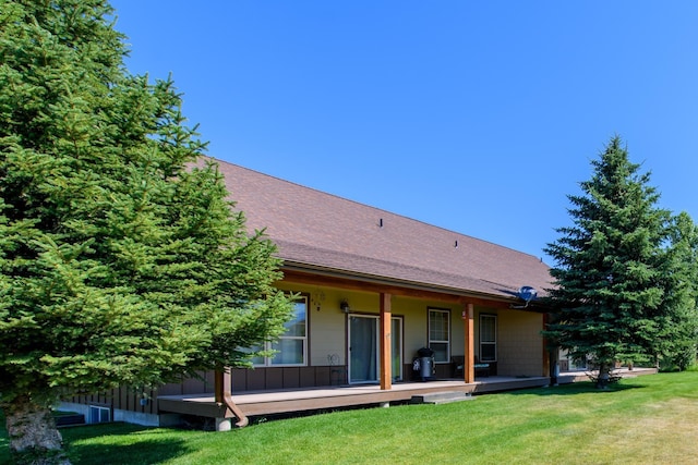 30 Demers Pl, Eureka, MT 59917 - back of house with a yard, a shingled roof, and covered porch
