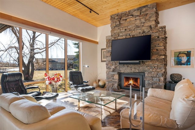 living room featuring wood ceiling and a fireplace