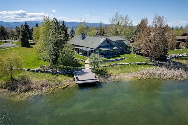 birds eye view of property with a water and mountain view