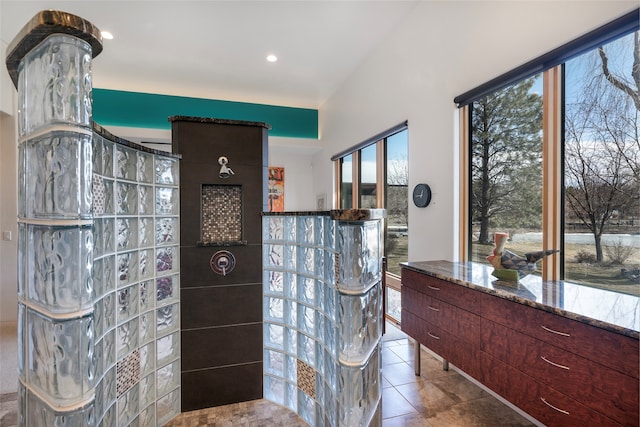 bathroom with tile patterned flooring and a wealth of natural light