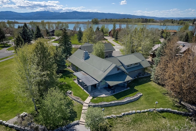 birds eye view of property featuring a water and mountain view