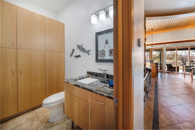 bathroom with vanity, toilet, and tile patterned flooring