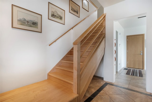 stairs featuring tile patterned flooring