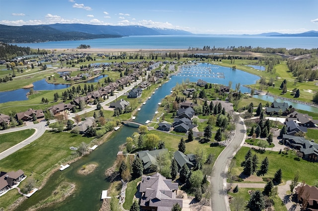 drone / aerial view featuring a water and mountain view