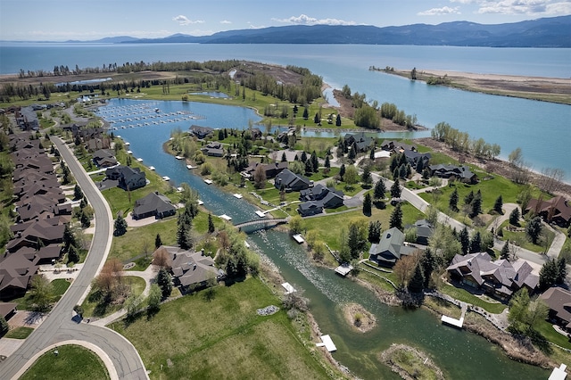 birds eye view of property with a water and mountain view