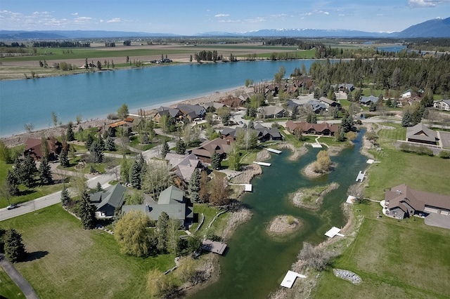 birds eye view of property with a water and mountain view