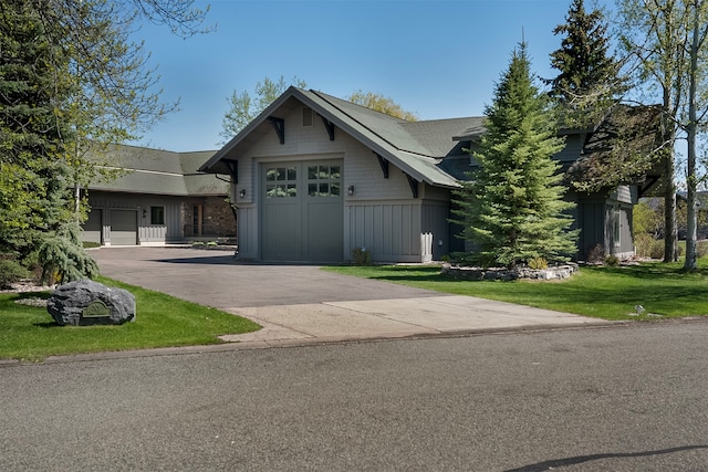 view of front of home with a front yard and a garage