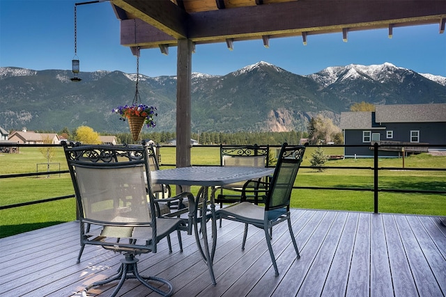 165 Jewel View Dr, Columbia Falls, MT 59912 - wooden terrace featuring a mountain view, outdoor dining space, and a yard