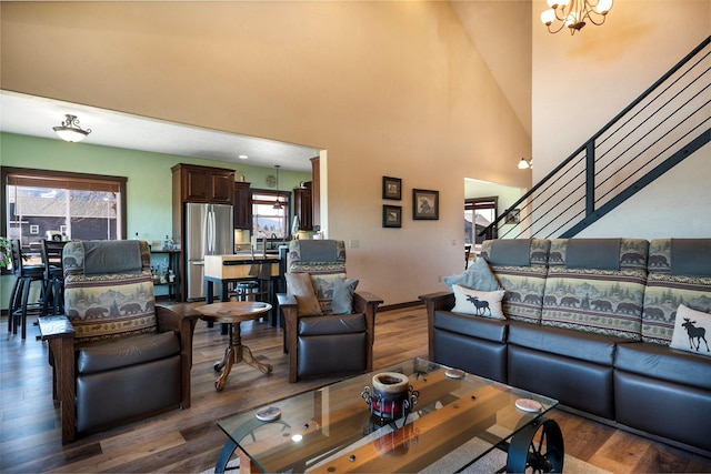 165 Jewel View Dr, Columbia Falls, MT 59912 - living area featuring plenty of natural light, wood finished floors, a chandelier, a towering ceiling, and stairway