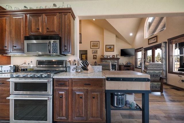 165 Jewel View Dr, Columbia Falls, MT 59912 - kitchen with appliances with stainless steel finishes, wood finished floors, a peninsula, recessed lighting, and open floor plan