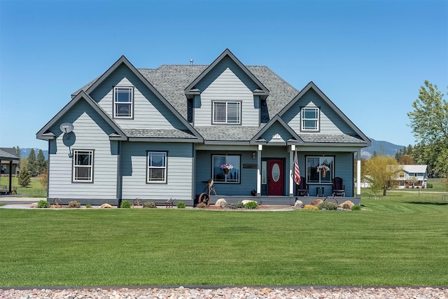 165 Jewel View Dr, Columbia Falls, MT 59912 - view of front of house with covered porch, a front lawn, and a shingled roof