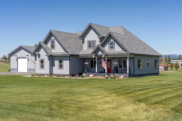165 Jewel View Dr, Columbia Falls, MT 59912 - view of front facade featuring a porch, a front yard, an attached garage, and roof with shingles