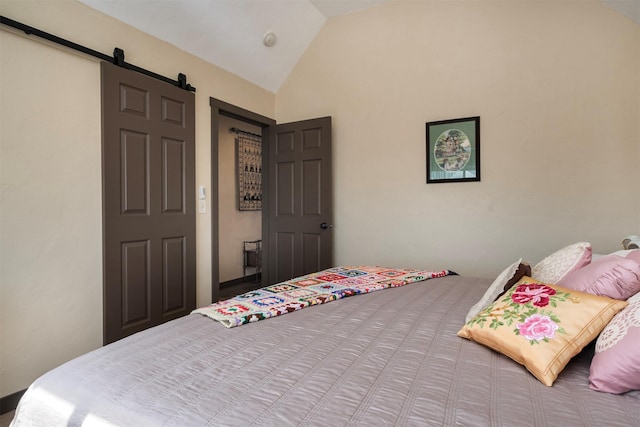 165 Jewel View Dr, Columbia Falls, MT 59912 - bedroom featuring lofted ceiling and a barn door