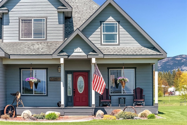 165 Jewel View Dr, Columbia Falls, MT 59912 - view of front facade featuring covered porch, a shingled roof, a front yard, and a mountain view