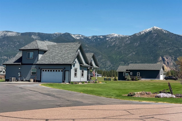 165 Jewel View Dr, Columbia Falls, MT 59912 - view of property exterior with a mountain view, a garage, asphalt driveway, and a yard