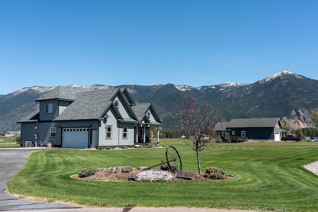 165 Jewel View Dr, Columbia Falls, MT 59912 - view of front of property featuring an attached garage, a mountain view, a front lawn, and driveway