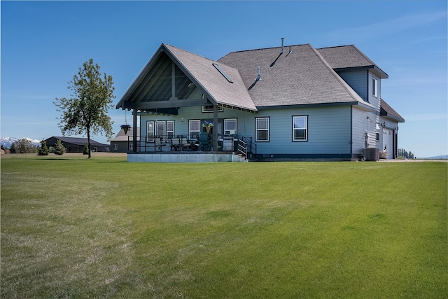 165 Jewel View Dr, Columbia Falls, MT 59912 - back of house featuring a yard, a shingled roof, and a garage