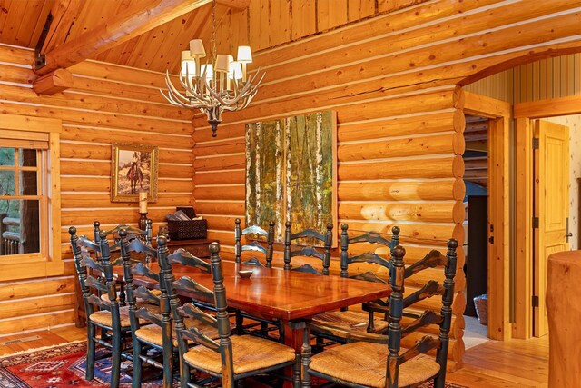 770 Pallo Trl, Hamilton, MT 59840 - dining space featuring wood-type flooring, a chandelier, log walls, and a wooden ceiling with exposed beams