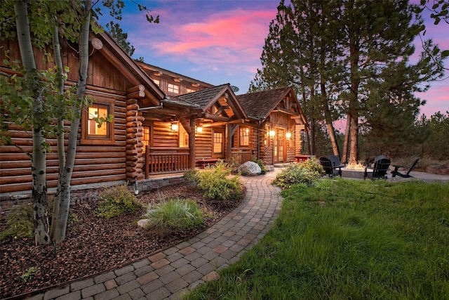 770 Pallo Trl, Hamilton, MT 59840 - log-style house featuring log exterior, an outdoor fire pit, board and batten siding, and covered porch