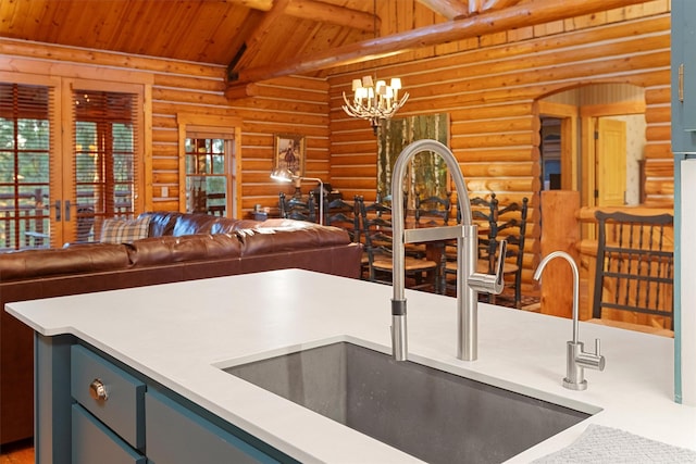 770 Pallo Trl, Hamilton, MT 59840 - kitchen featuring wooden ceiling, rustic walls, a chandelier, hanging light fixtures, and light countertops
