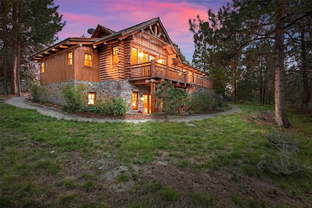 770 Pallo Trl, Hamilton, MT 59840 - view of home's exterior featuring stone siding, a lawn, board and batten siding, and log siding