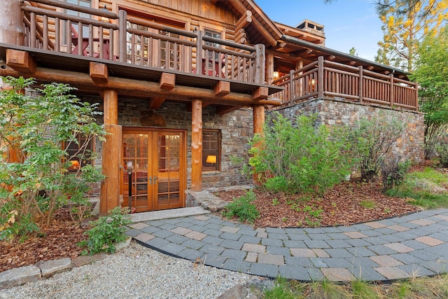 770 Pallo Trl, Hamilton, MT 59840 - doorway to property with stone siding, a balcony, log exterior, and french doors