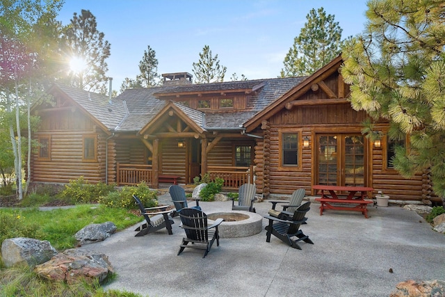 770 Pallo Trl, Hamilton, MT 59840 - back of property featuring an outdoor fire pit, log exterior, french doors, and a patio