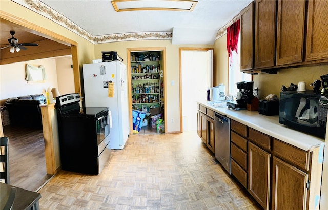 kitchen with ceiling fan, appliances with stainless steel finishes, and light parquet flooring