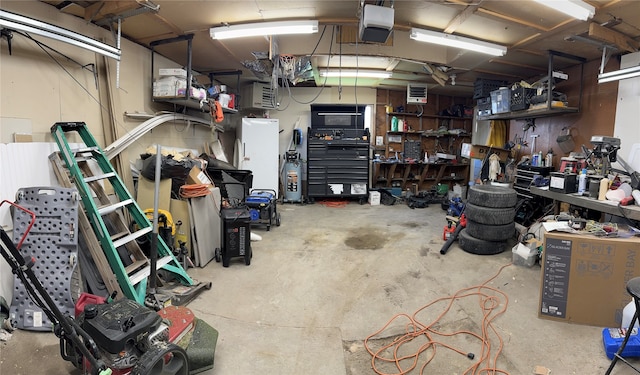 garage with a garage door opener and a workshop area