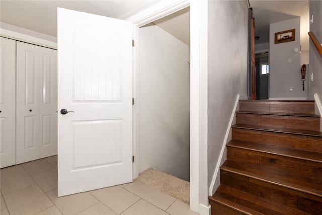 stairway with light tile flooring