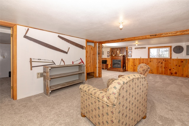 living room featuring beam ceiling, a textured ceiling, and light colored carpet