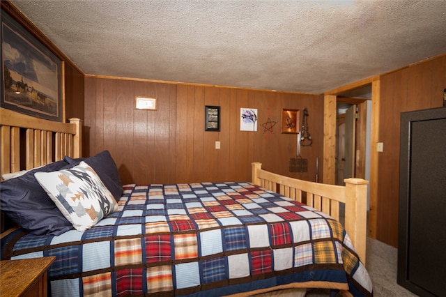 bedroom with a textured ceiling and wooden walls