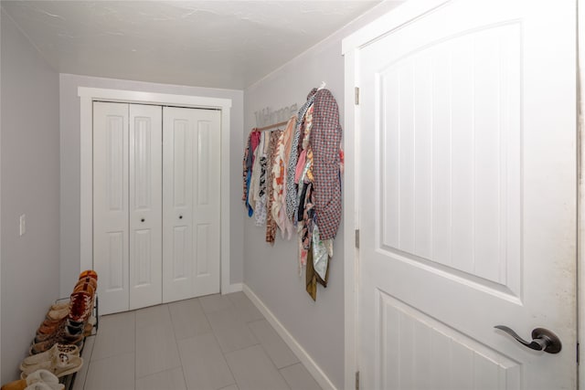 doorway to outside featuring light tile flooring