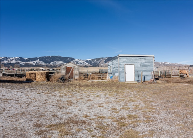 view of outdoor structure featuring a rural view and a mountain view