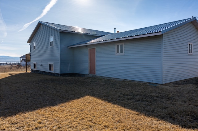 view of property exterior featuring a lawn