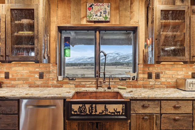 kitchen featuring a mountain view and light stone counters