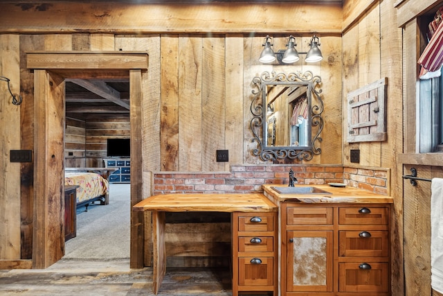 bathroom with wooden walls, hardwood / wood-style floors, and vanity