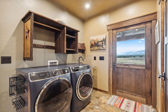 clothes washing area featuring cabinets and independent washer and dryer