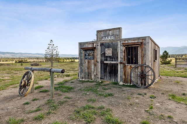 view of outbuilding with a mountain view and a rural view