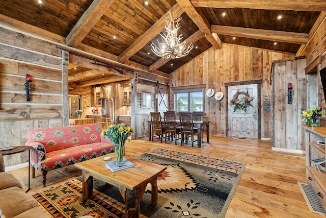 living room featuring wood ceiling, light hardwood / wood-style floors, wood walls, beam ceiling, and a notable chandelier