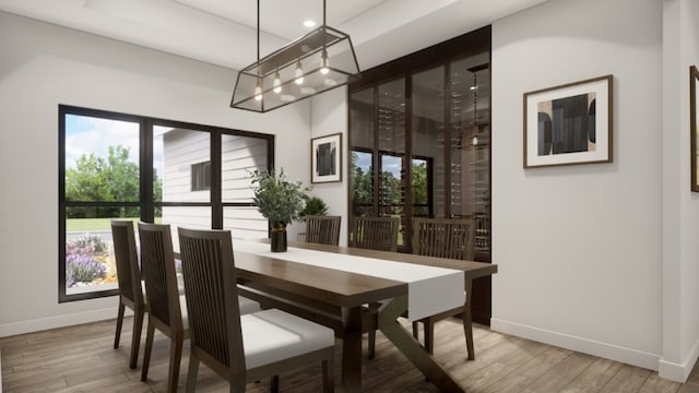 dining room with light hardwood / wood-style floors and an inviting chandelier