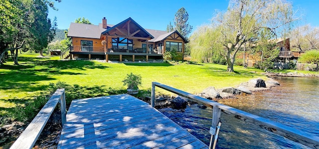 dock area featuring a wooden deck and a yard