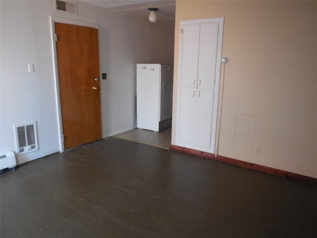 empty room with dark hardwood / wood-style flooring