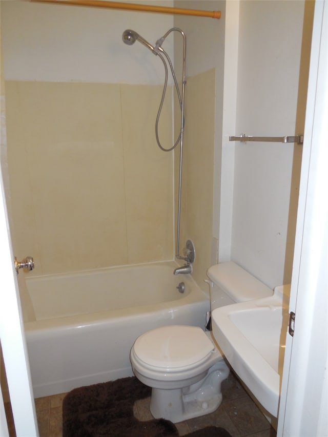 bathroom featuring toilet, tile flooring, and tub / shower combination