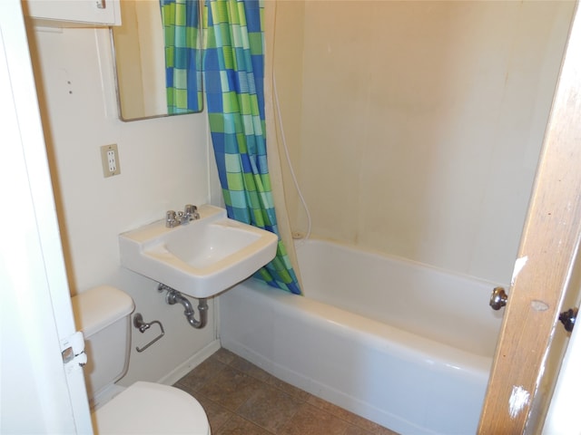 full bathroom featuring sink, tile floors, toilet, and shower / bathtub combination with curtain