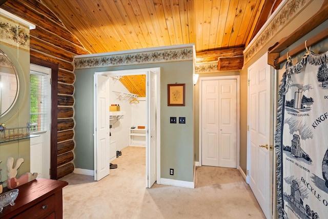 hall featuring log walls, vaulted ceiling, light colored carpet, and wooden ceiling