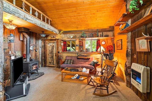 living area with lofted ceiling, carpet floors, wooden ceiling, heating unit, and a wood stove