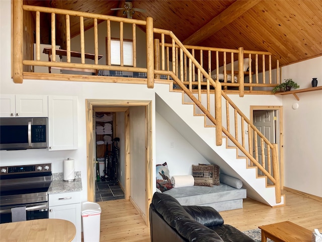 living room featuring ceiling fan, high vaulted ceiling, light hardwood / wood-style floors, and wooden ceiling