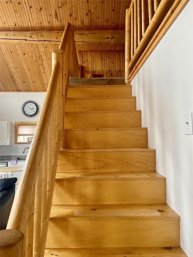 stairway with beam ceiling and wood ceiling