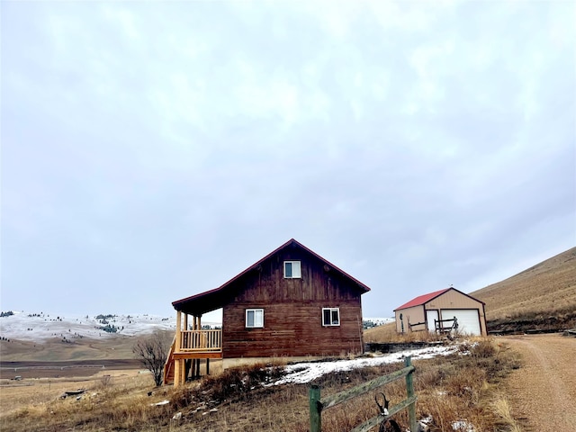 view of property exterior featuring an outdoor structure and a garage